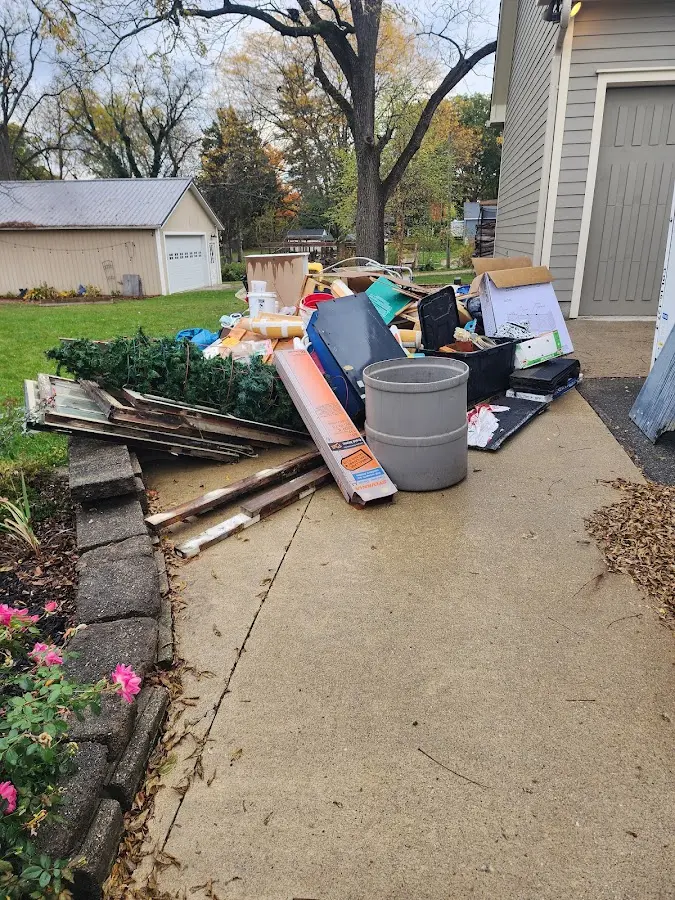 Dumpster being loaded with debris for 30 Yard Dumpster Rental in Walled Lake
